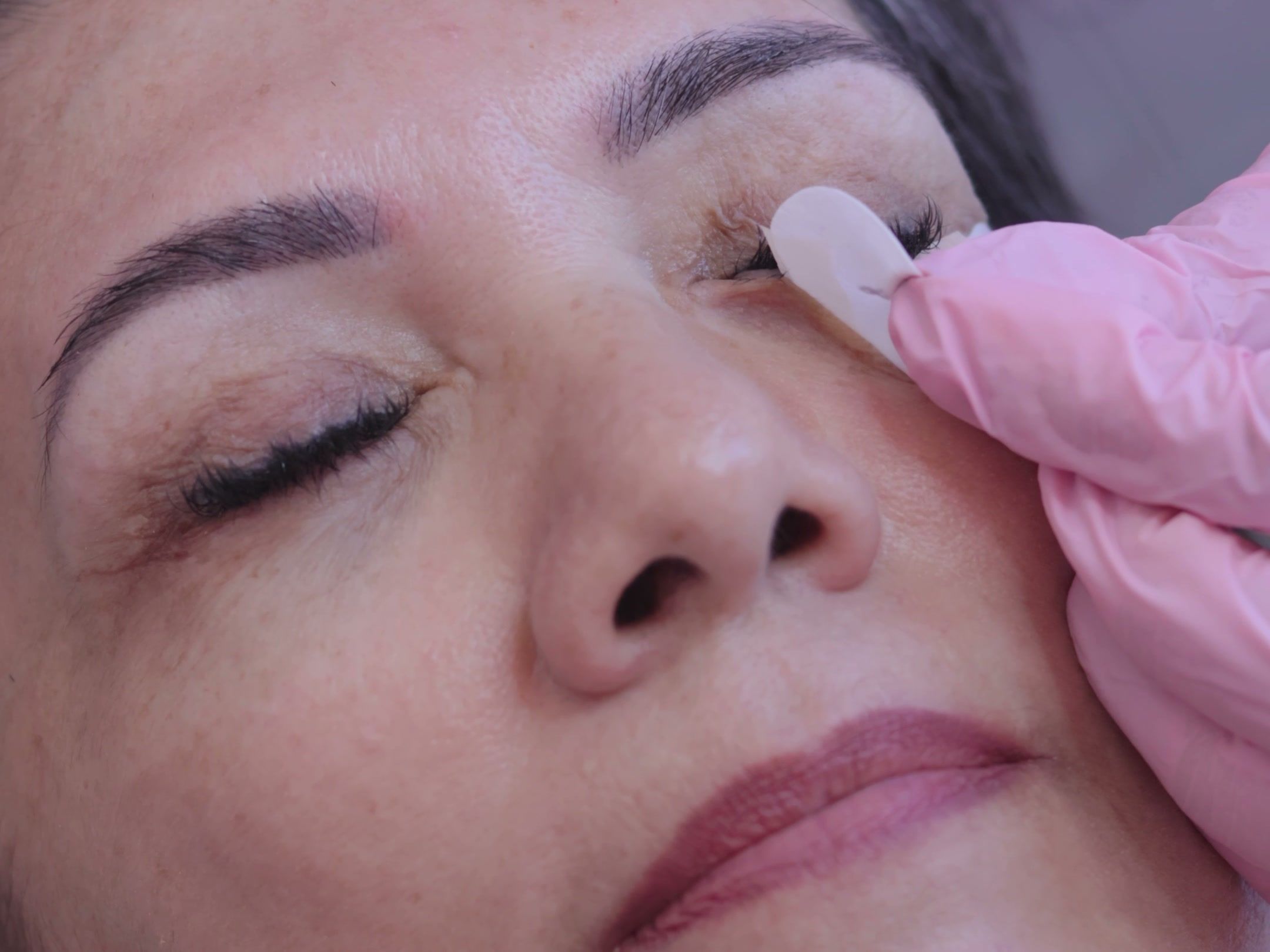 Cliente de olhos fechados com extensão de cílios recém-aplicada na Clínica da Barbe